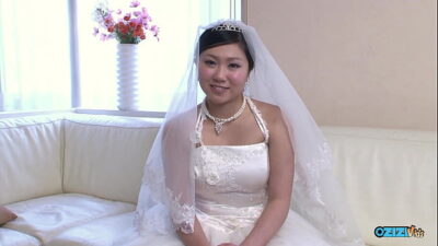 The new asian wife is still dressed in her wedding gown when someone visited her